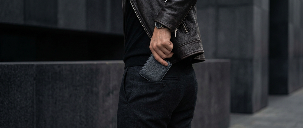 Man carrying a minimalist leather wallet in his back pocket.